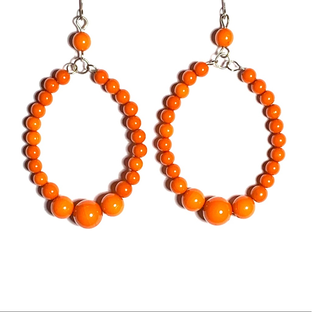 Orange beaded oval earrings